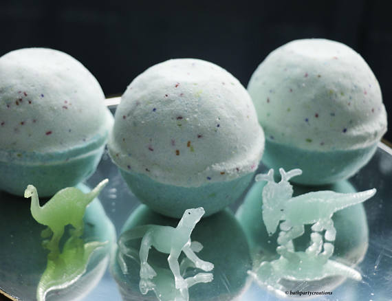 Plastic dinosaurs in front of bath bombs