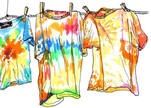 Tie dyed shirts, hanging on a line.