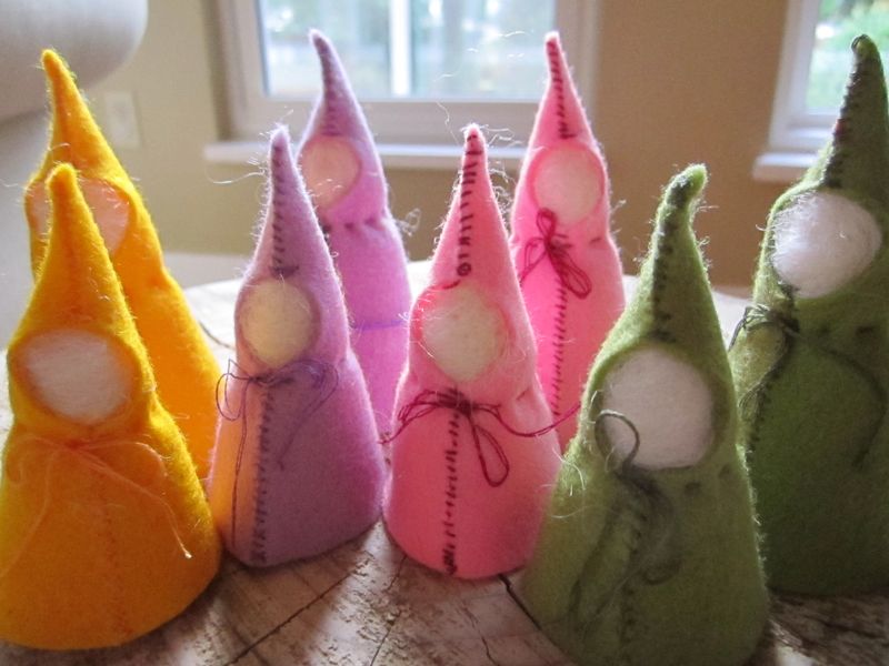 Faceless felt gnomes in hooded capes.
