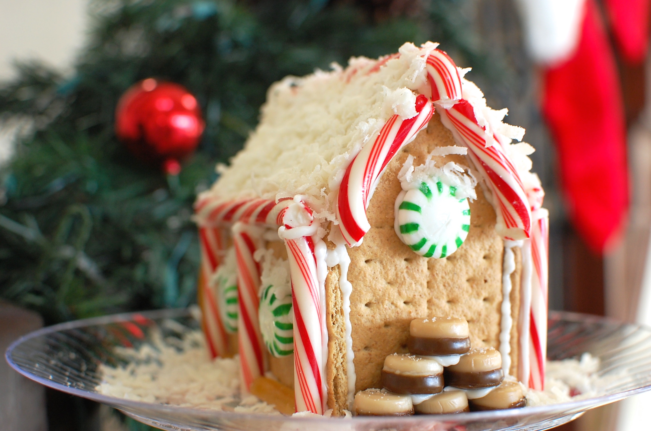 A gingerbread house made of graham crackers with a coconut roof.