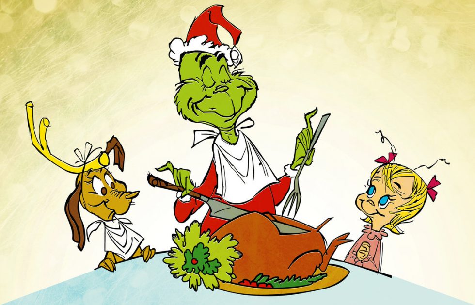 The Grinch is carving the roast beast, flanked by his dog and Cindy Lou Who.