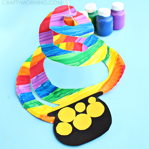 Multicolored paper plate cut into a long swirl with a pot of gold glued to the bottom
