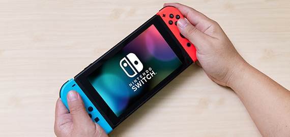 Hands holding a Nintendo Switch