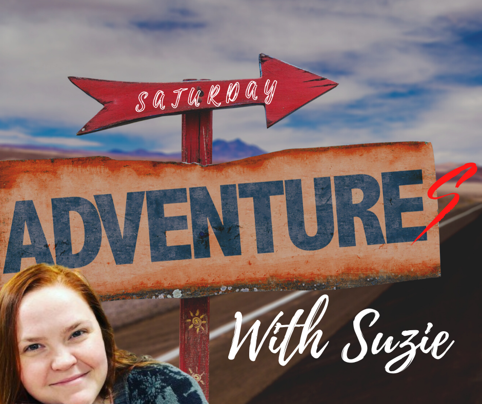 Suzie in front of a sign that says "Saturday Adventures"