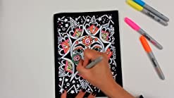 Hand coloring a black velvet poster with Sharpies.