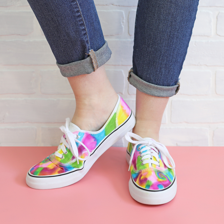 Two feet wearing colorful shoes.