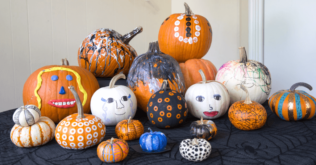 A pile of decorated pumpkins