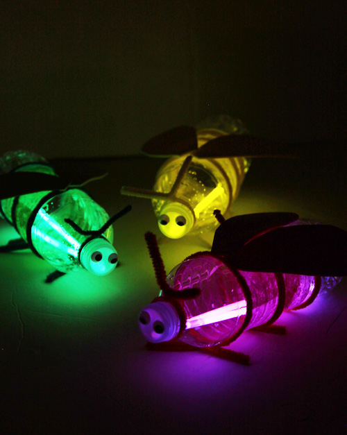 Fireflies made out of soda bottles and glow sticks.