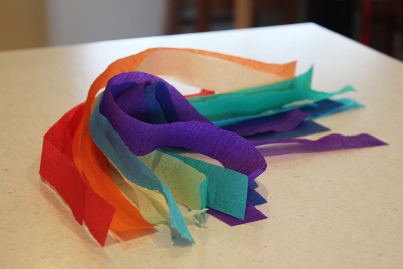 A pile of colorful tissue paper, cut into strips.