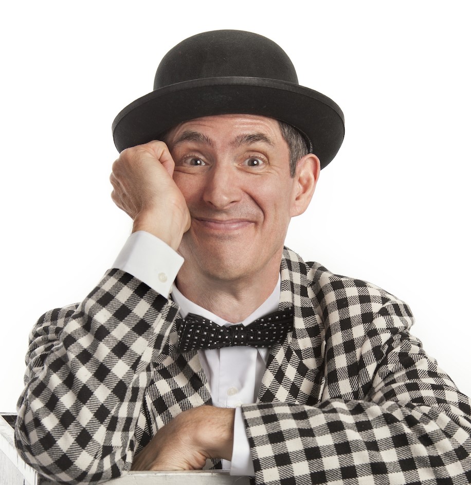 Man with a bow tie and bowler hat, looking into the camera.