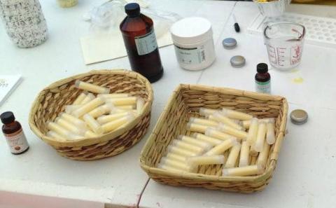 Two baskets full of lip balm in cylindars.