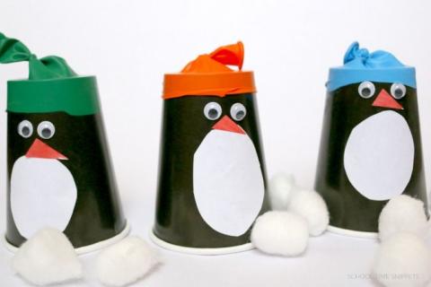 Penguins made out of paper cups with little balloon hats.