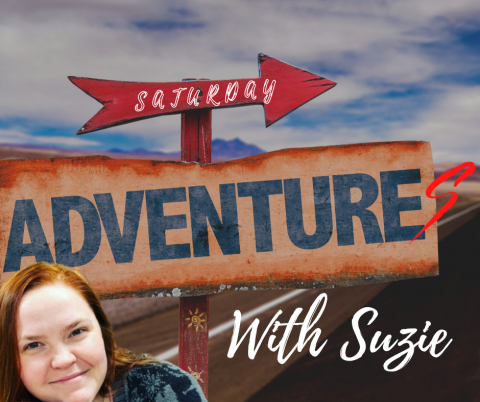 Suzie in front of a sign that says "Saturday Adventures"