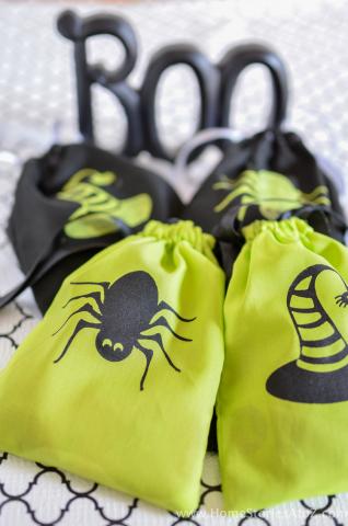 Four Halloween treat bags in front of the word, "Boo."