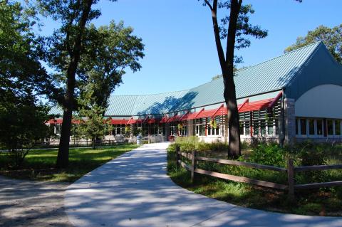 Path leading up to a long, one level building.