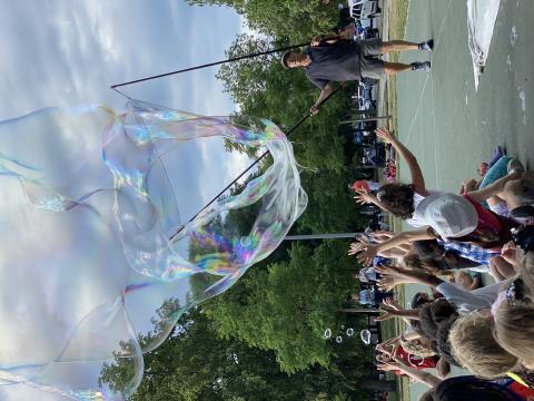 Man blowing giant bubbles.