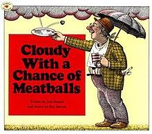 A man holding an umbrella while it rains meatballs.