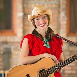 Woman in a cowboy hat holding a guitar