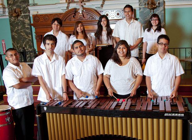 Group of youths standing behind a marimba