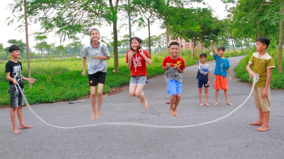 Group of boys and girls jumping rope.