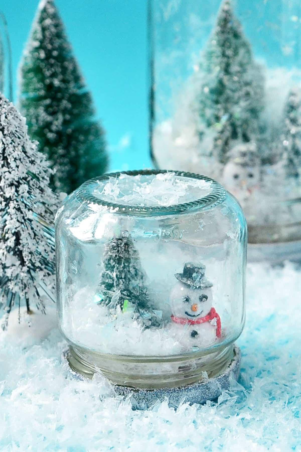 a snow globe made out of a baby food jar.