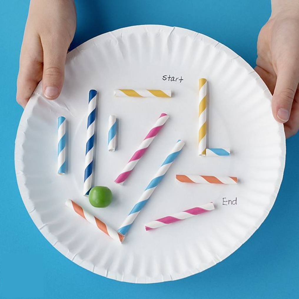 A paper plate with straws glued to it.